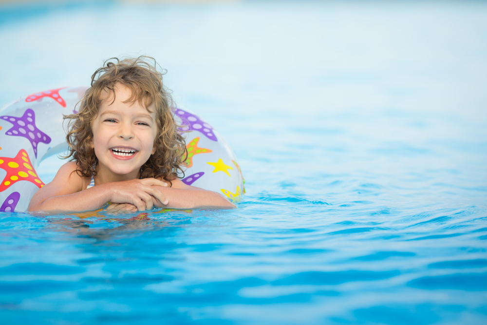 little girl in pool after swimming pool construction is complete